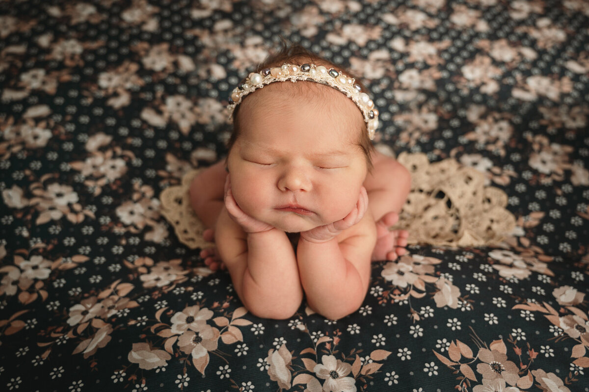 Newborn Greater Toronto Photographer,  baby girl in pearl headband in the froggy pose on a vintage floral backdrop, by Tamara Danielle Photography.