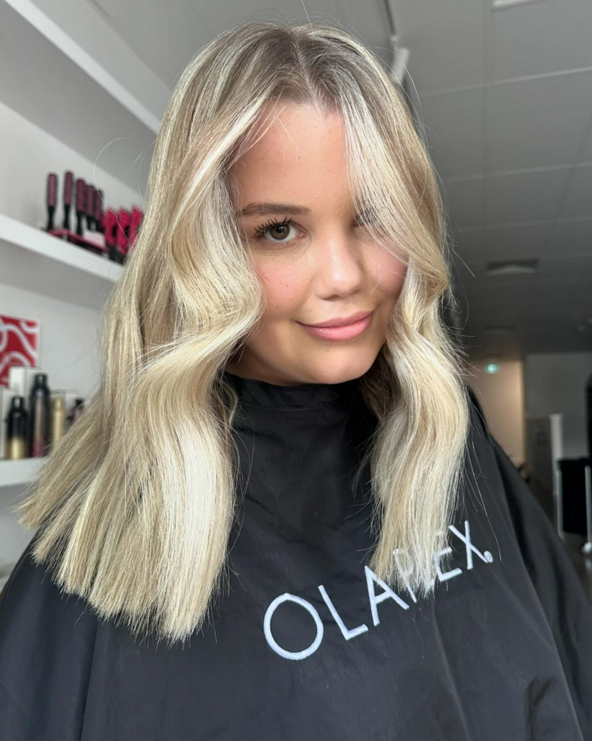 Girl smiling into camera with blonde curled hair