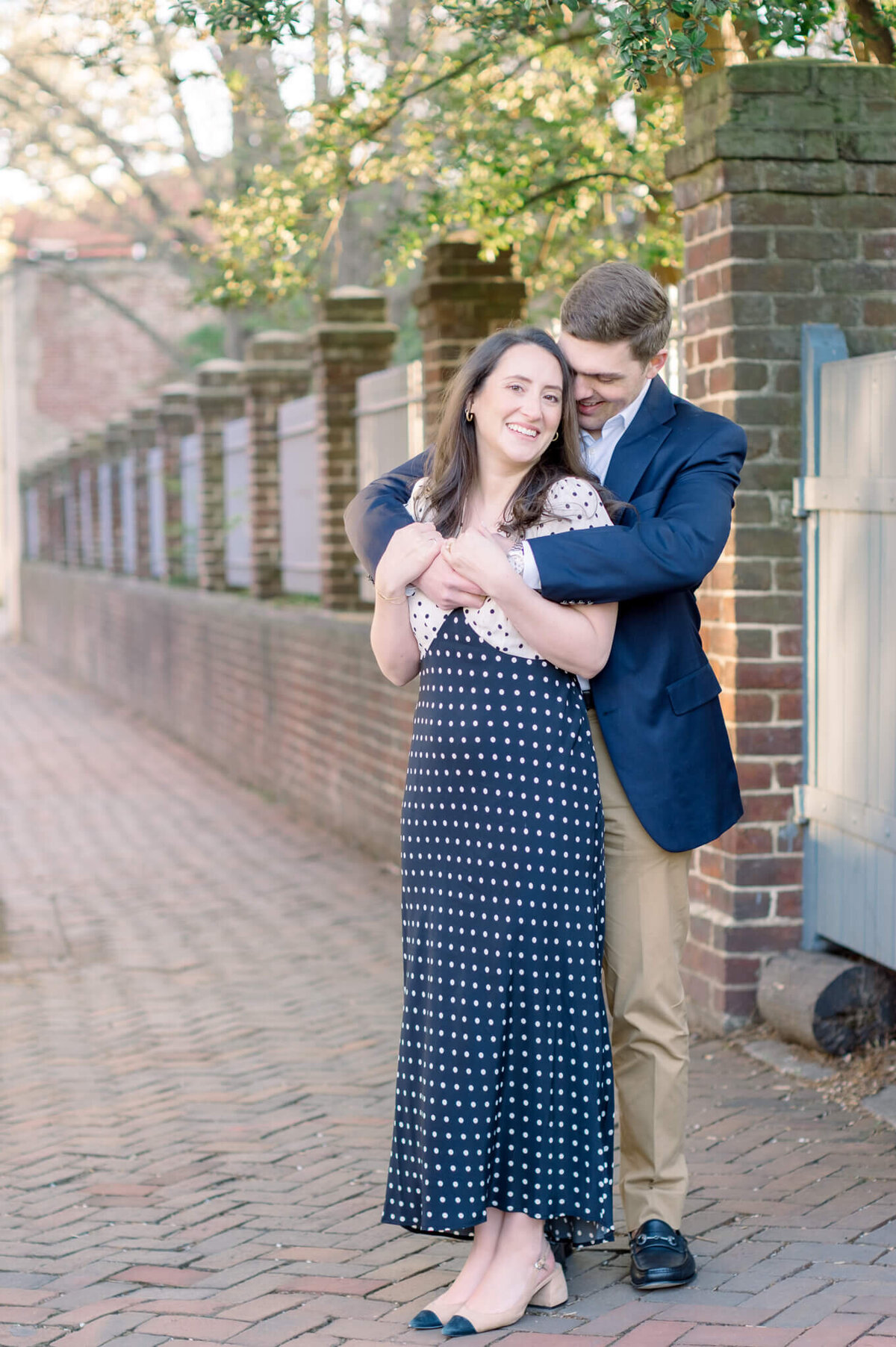 Couple taking engagement portraits in Old Town Alexandria, Virginia. Captured by Charlottesville Wedding Photographer Bethany Aubre Photography.