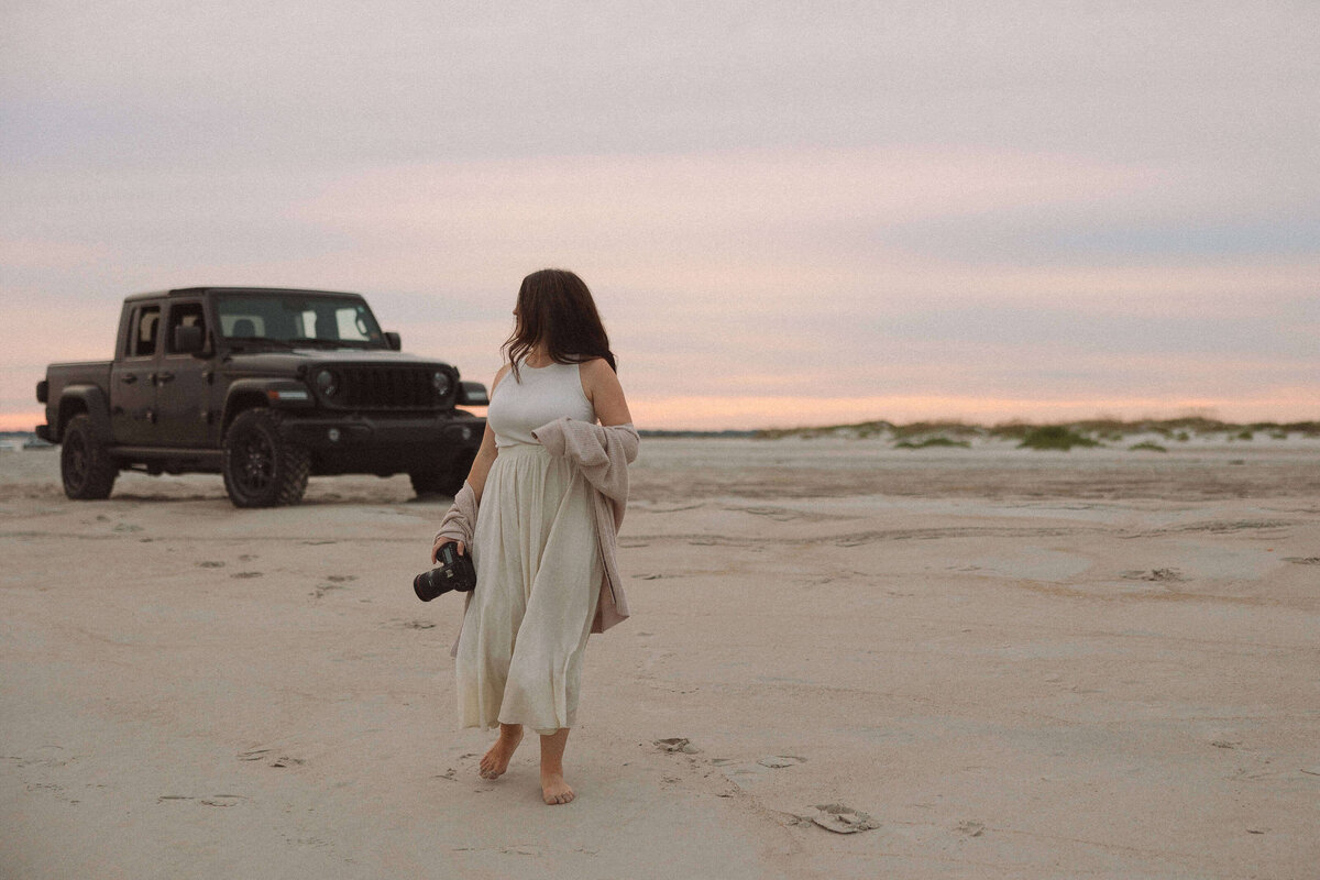 commercial photographer standing on a beach