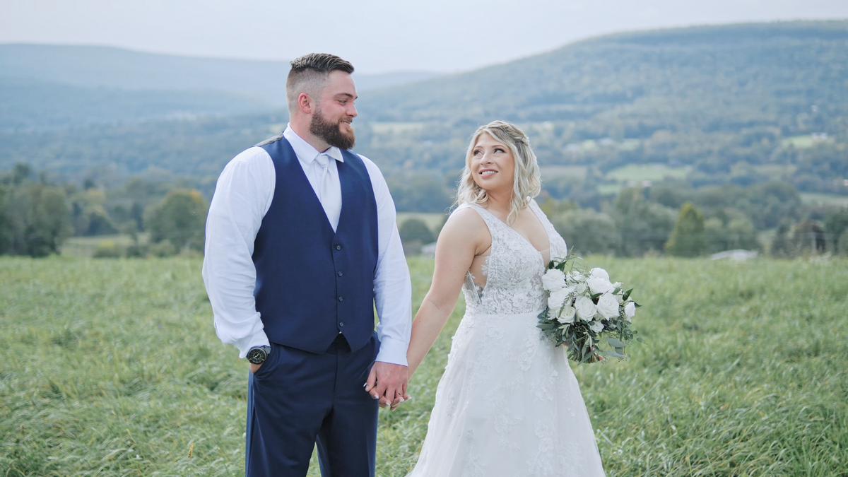 Bride and Groom looking at each other in field at the Sablewood