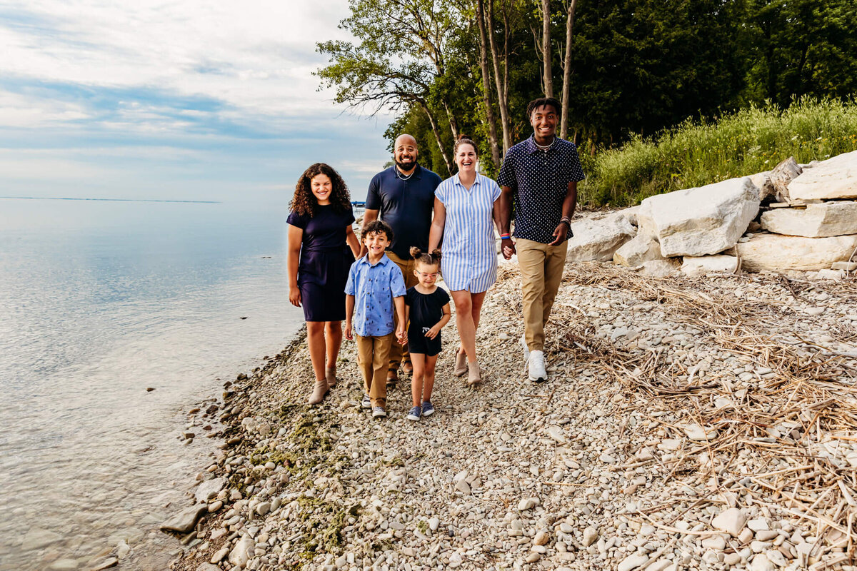 family walking along lake Michigan