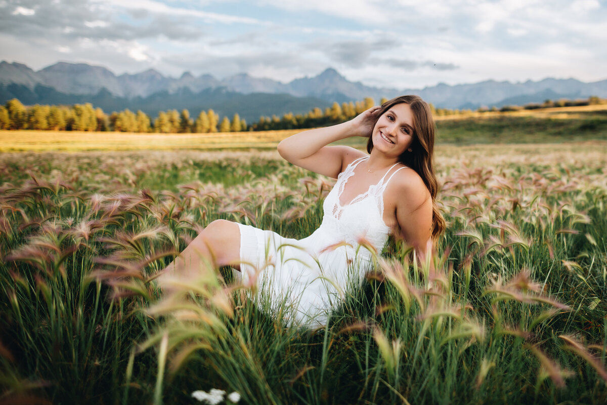 Kiersten poses in a field for her Telluride senior pictures.