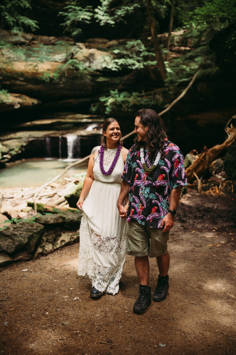 Stylish Hawaiian style couple walk along Old Mans Cave
