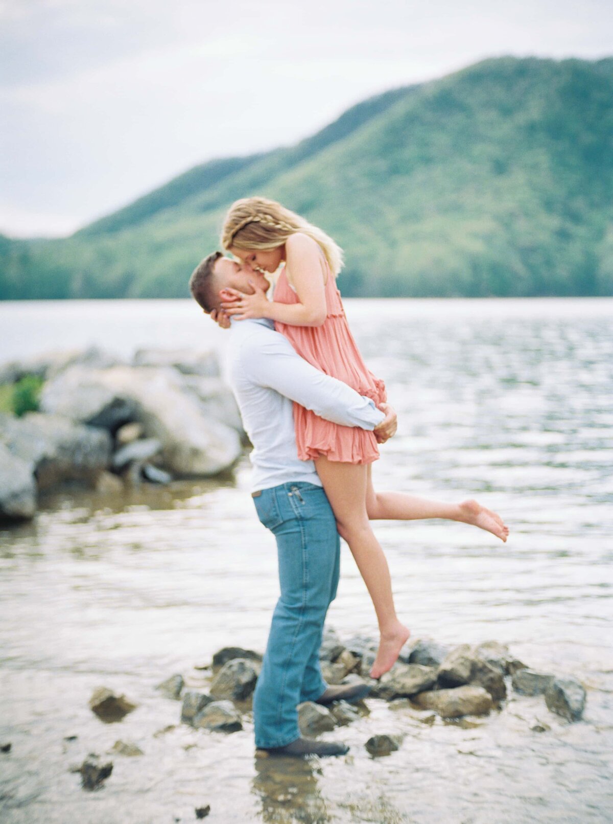 Watagua Lake engagement photo of cute couple kissing in the water by danielle defayette