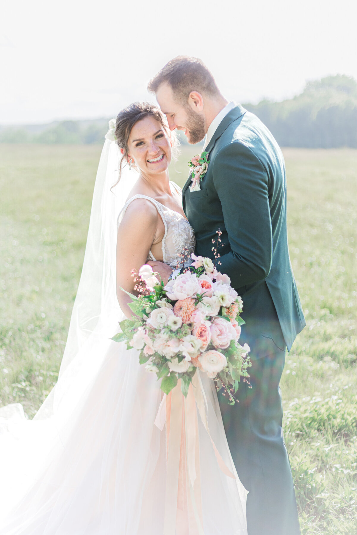 Bride and groom in a field in New Hampshire