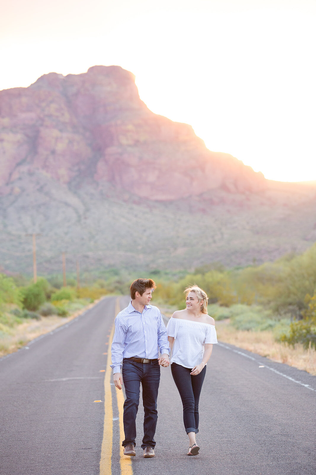 Engaged couples walking on the street photographed by DePoy Studios, Phoenix best wedding photographers.