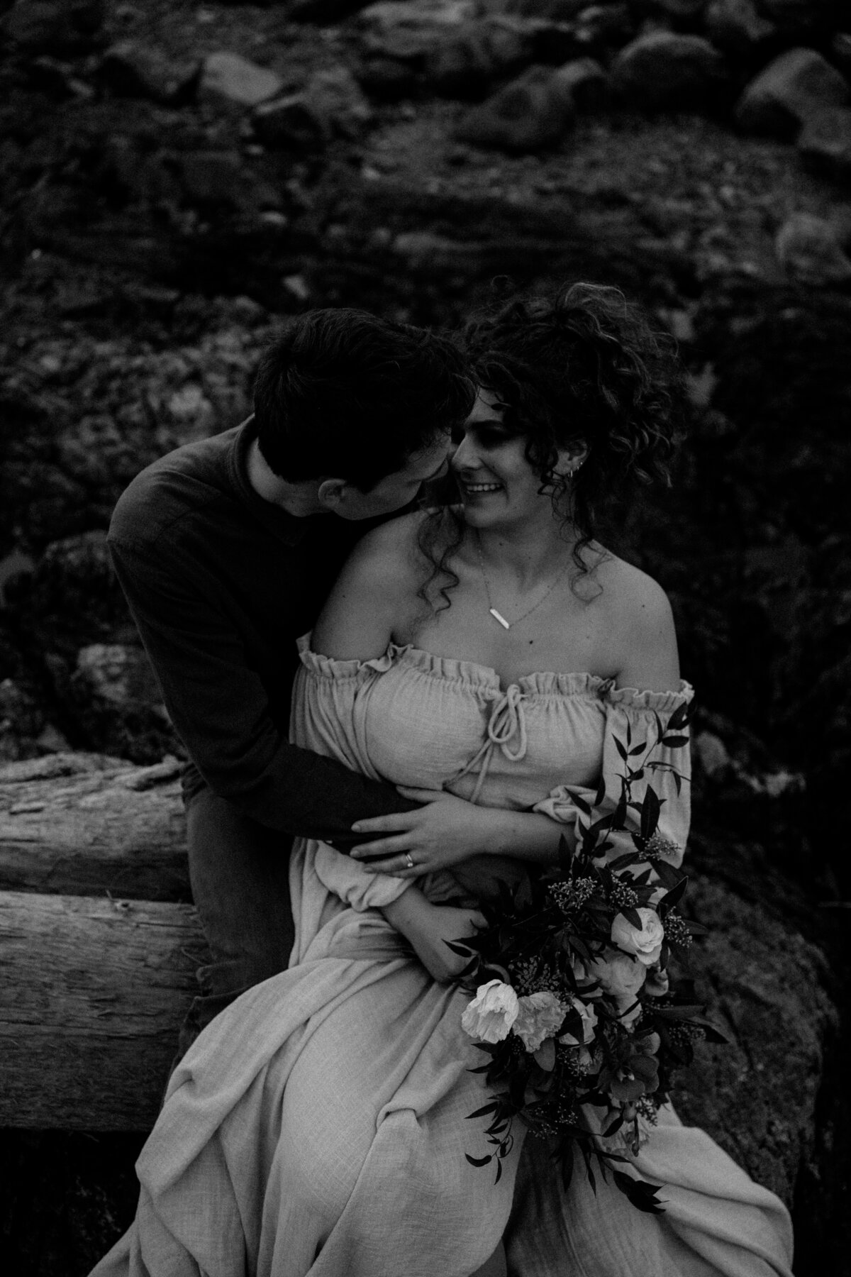 black and white image couple sitting embracing