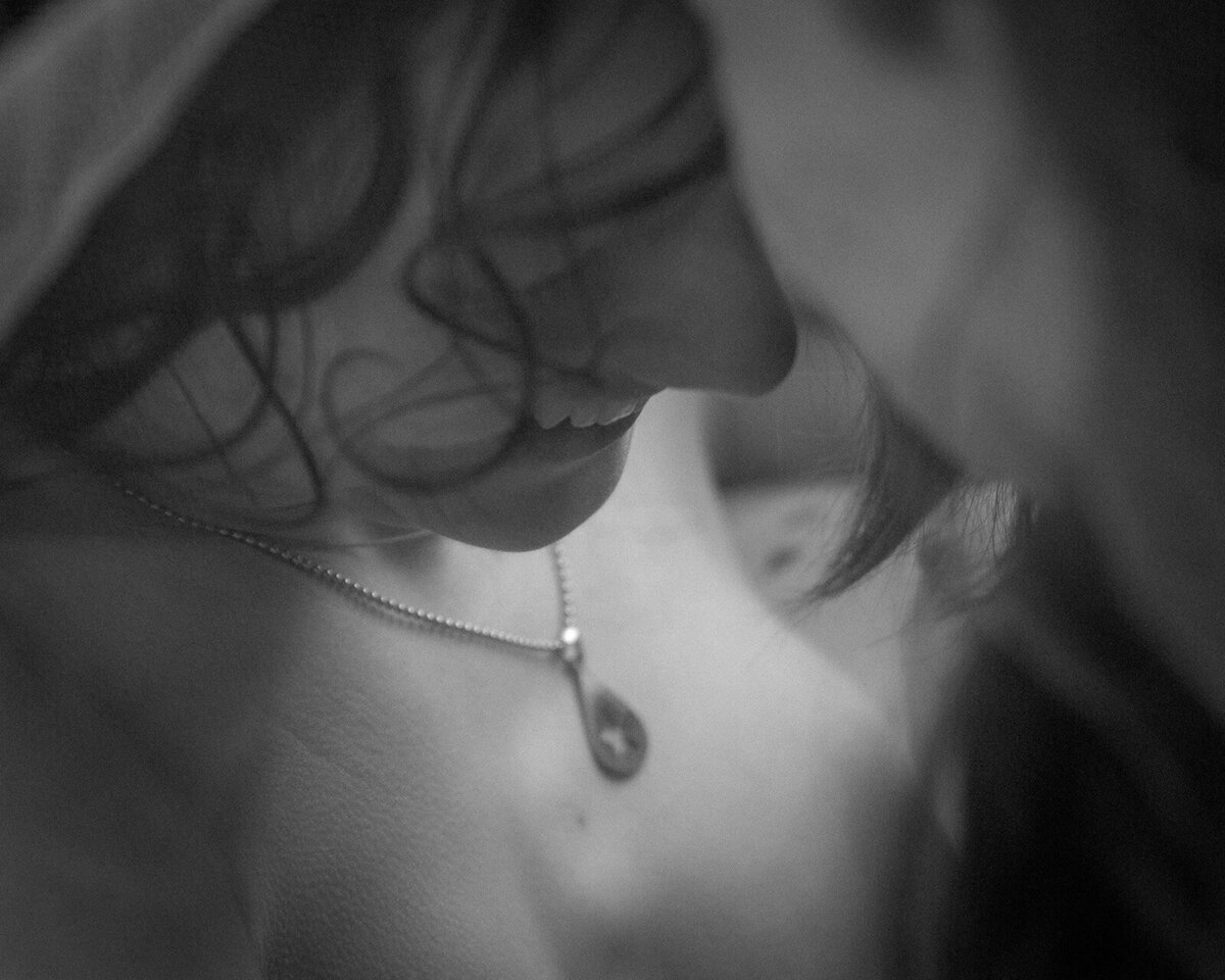 Intimate boudoir photo shoot,  two  young woman kiss