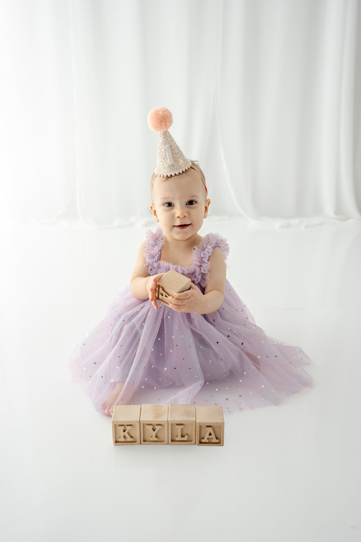 Girl in birthday hat during themed cake smash session— captured by Alliston and Barrie cake smash photographer.