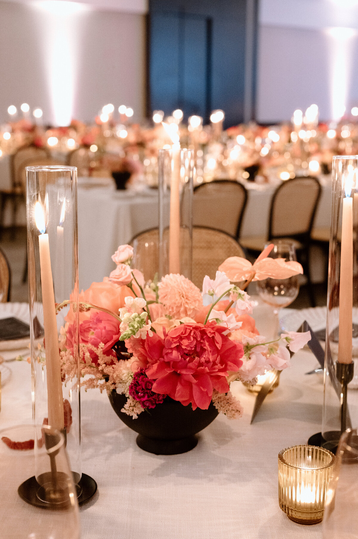 A close-up of romantic table decor with candles and floral centre pieces at a luxury wedding in Toronto.