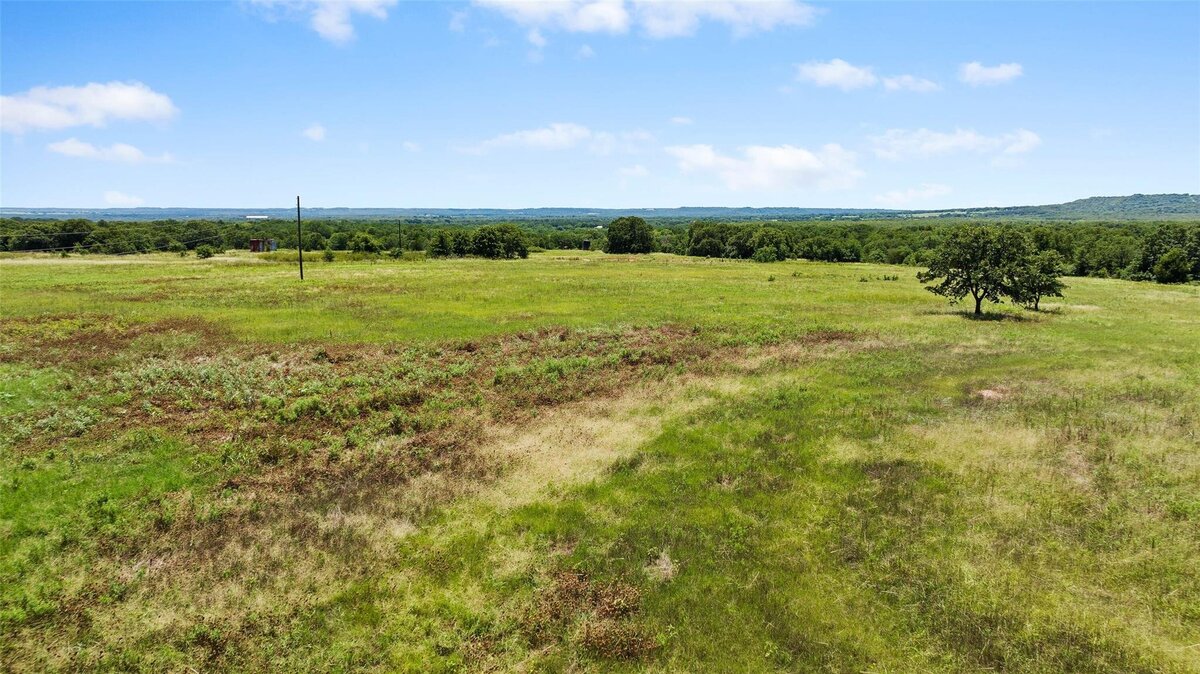Aerial view of 55-acre property with mature post oaks in Saint Jo, TX