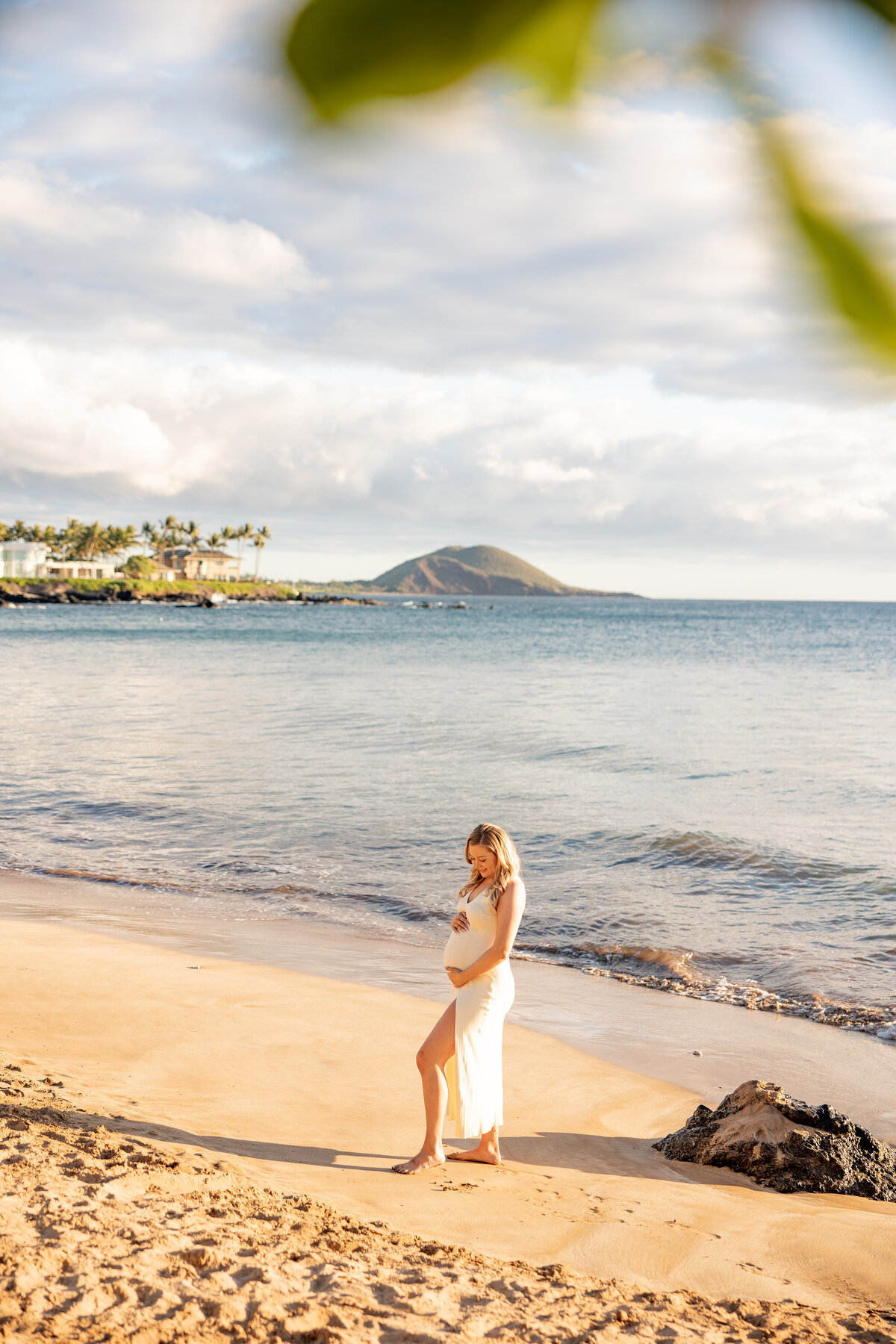 Maui Couples Photographer captures beach maternity photos of woman holding belly