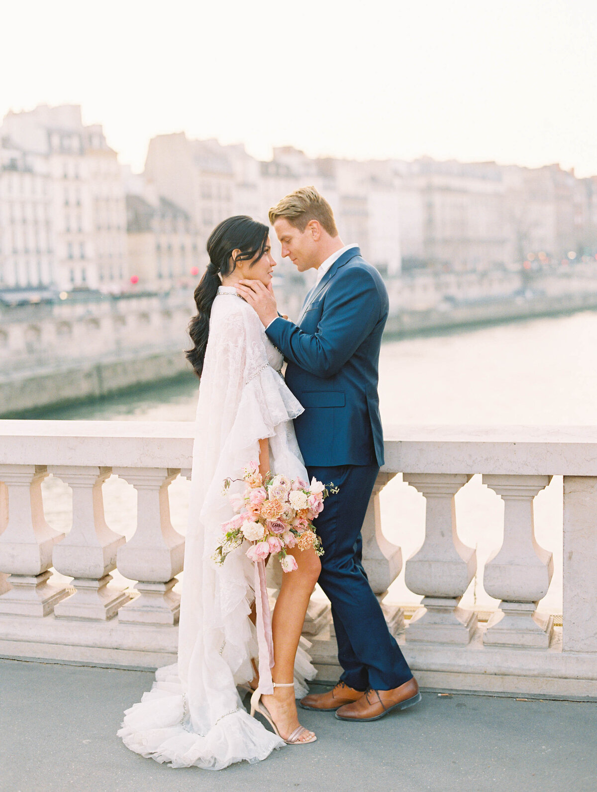 Bride and groom at the Seine in Paris, France for Paris destination wedding
