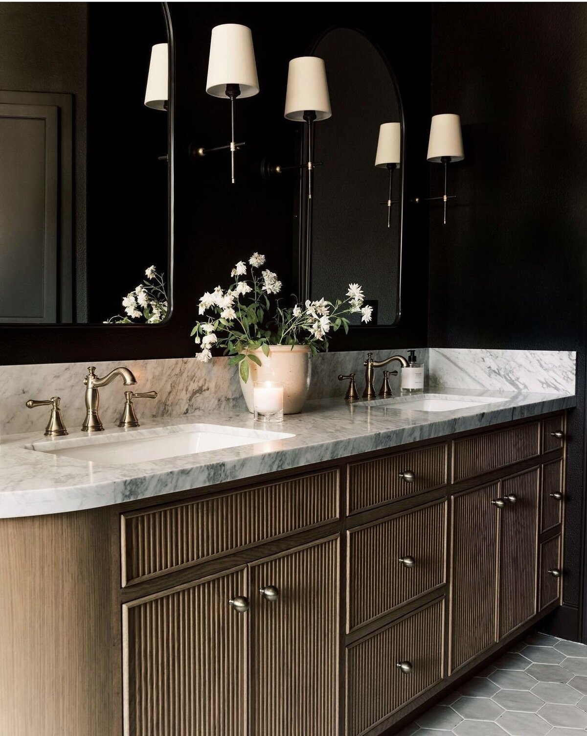 Beautifully remodeled bathroom with dark colors and organic modern woods and gold tones house shown by Craig Lerch
