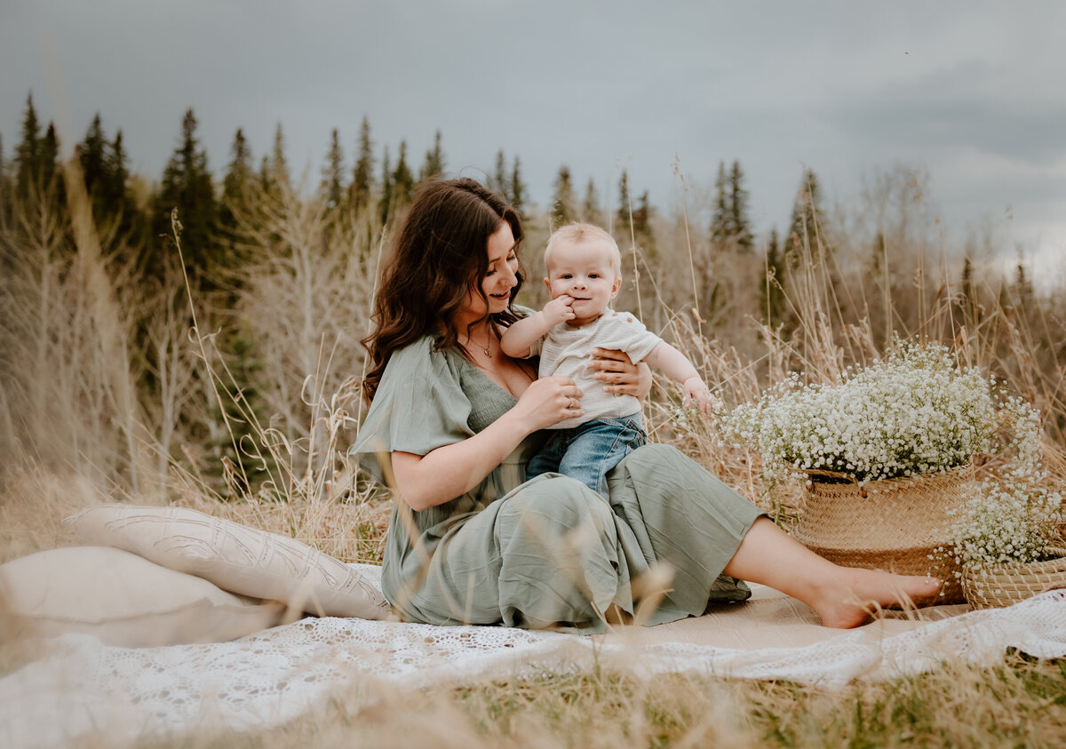 Mom holding son on a blanket