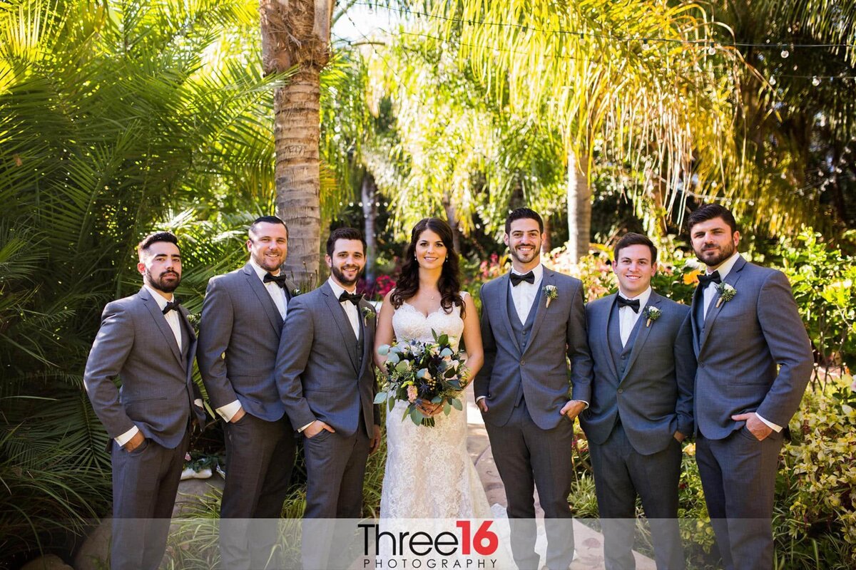 Bride poses with the Groomsmen