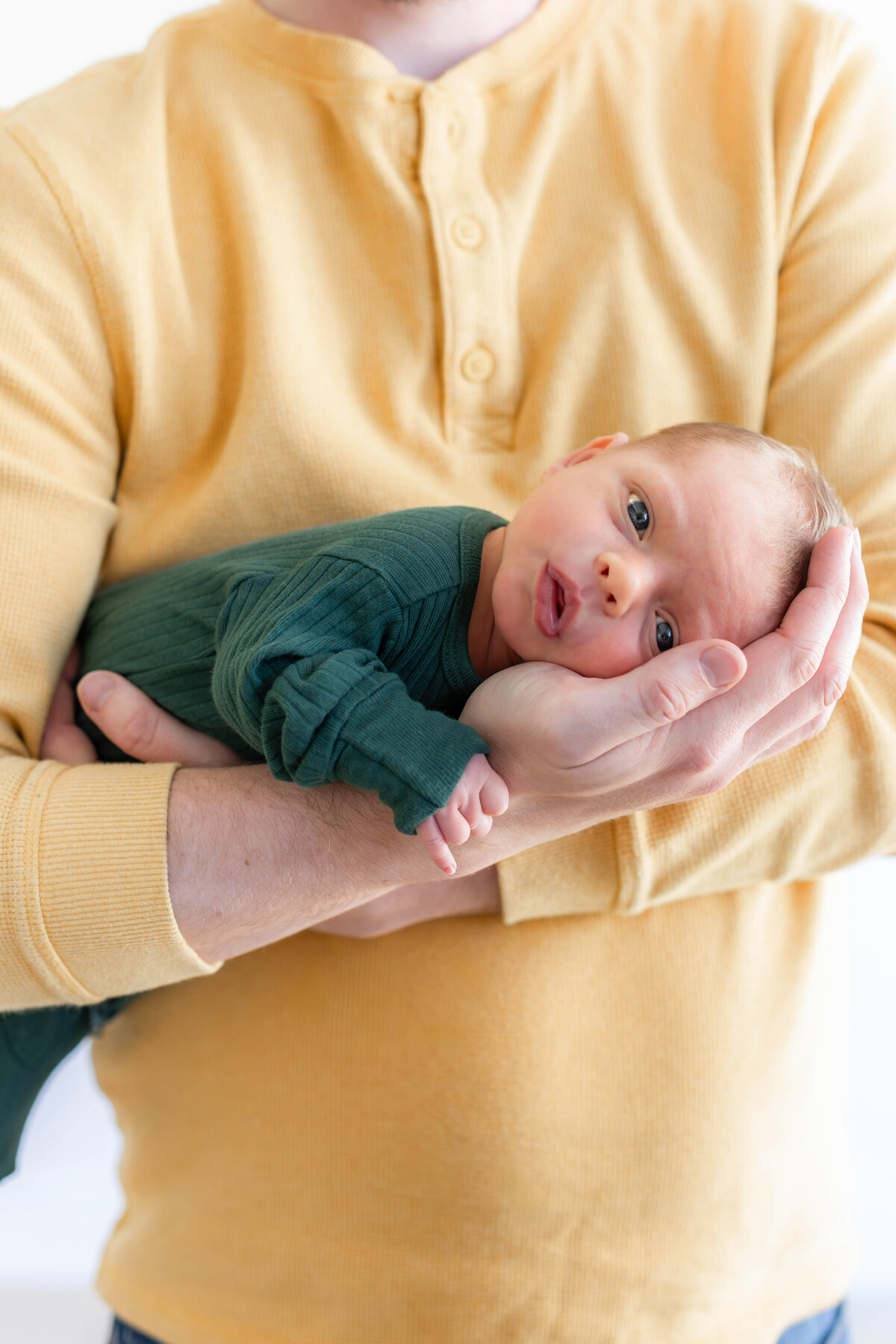 Close up image of awake newborn in bright and clean studio, taken by a Provo Utah photographer.