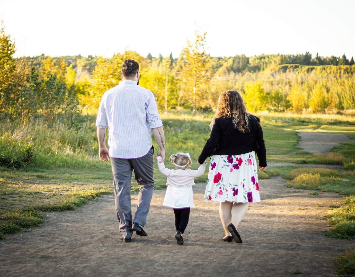 a family walking away in a field in Edmonton