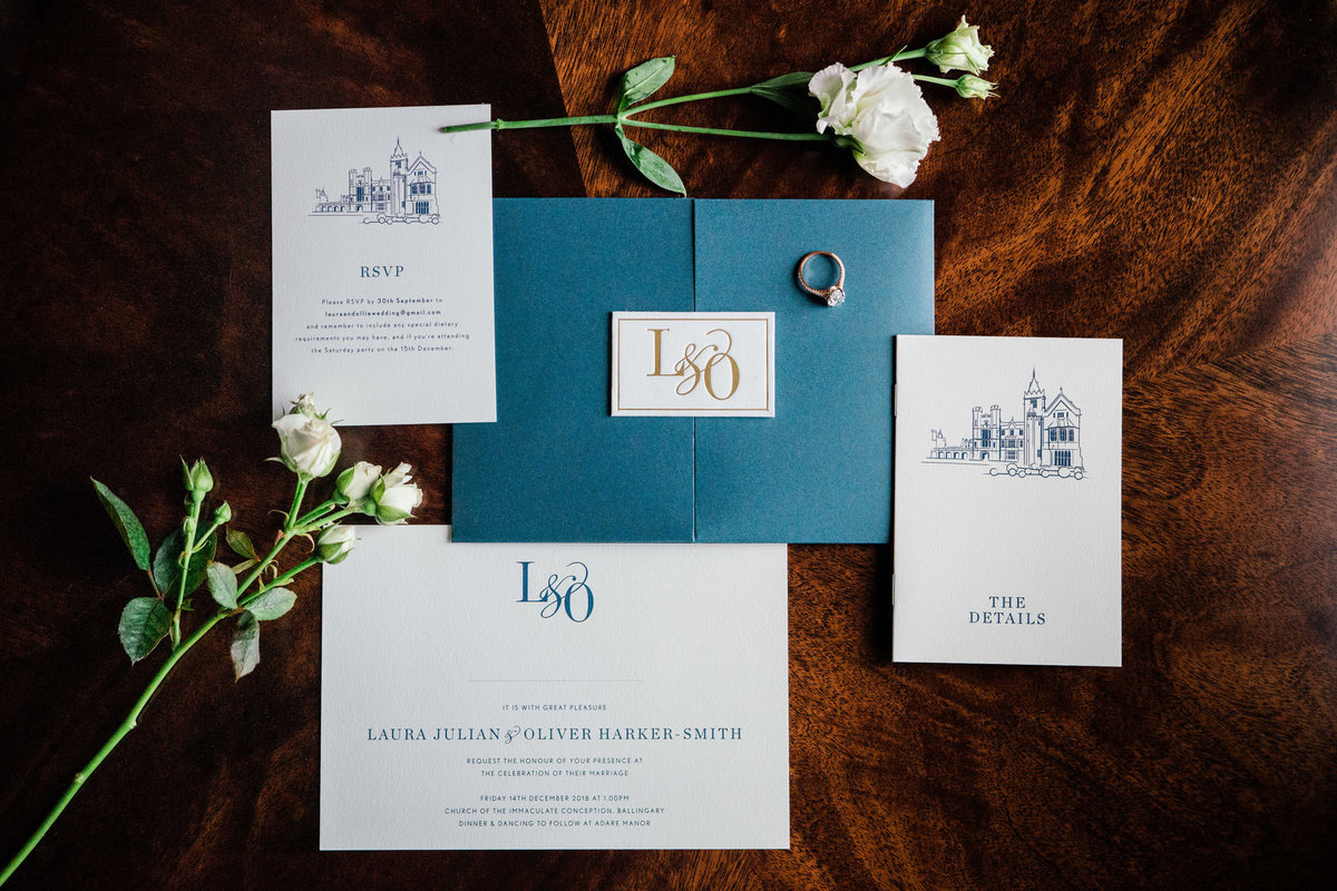 A flat lay photograph of the wedding invites wedding rings and details at adare Manor