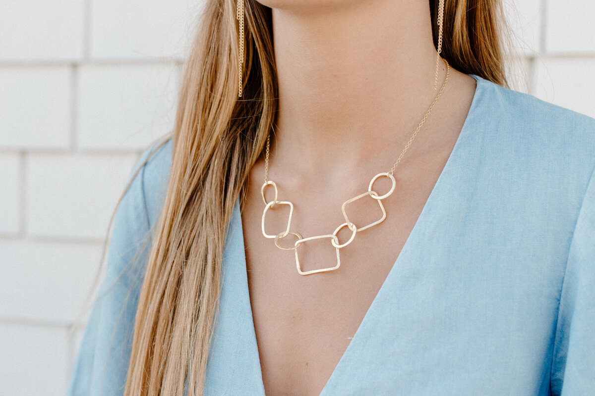 gold minimal necklace on girl with blue dress