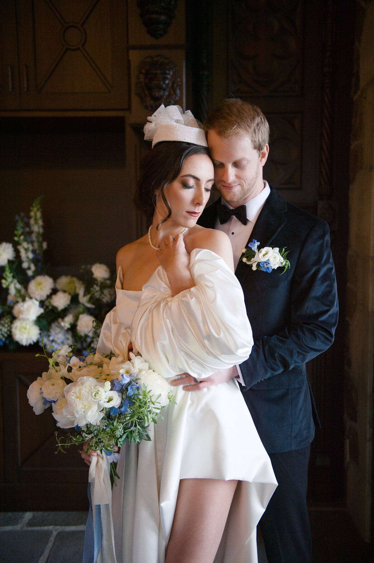luxury bride holding bouquet with groom inside chateau de lis