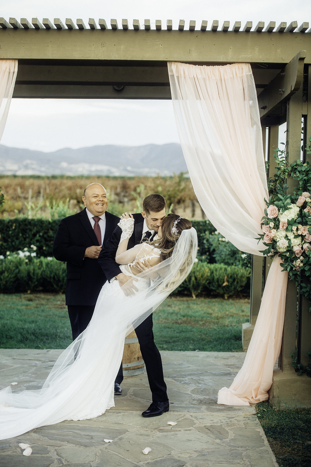 Wedding Photograph Of Bride And Groom Bending While Kissing Los Angeles
