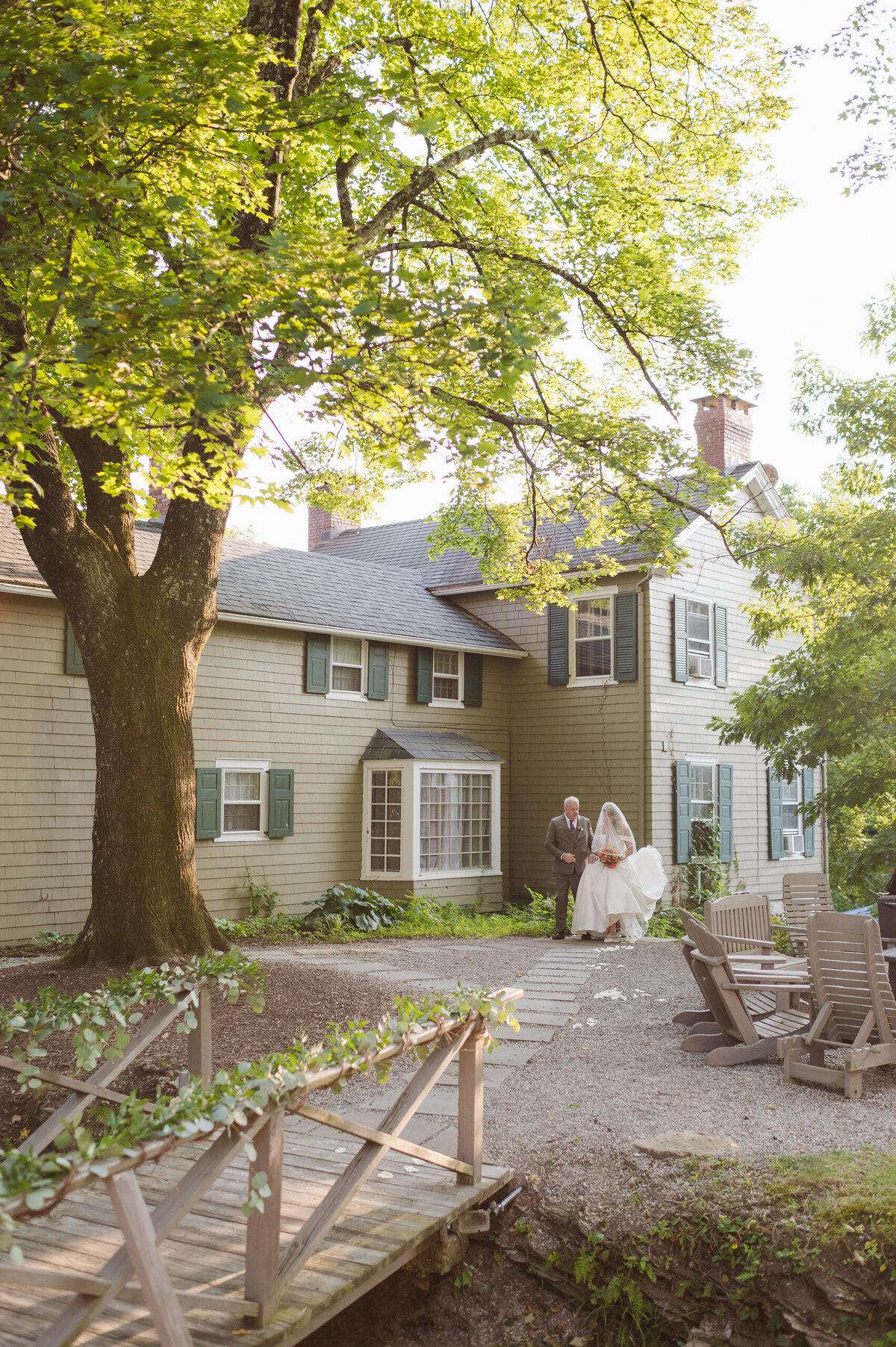 wedding ceremony bridge entrance at the whimsical wedding venue the inn at millrace pond nj