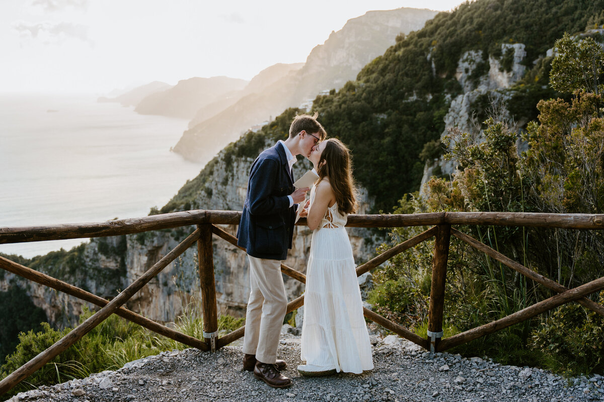 Couple sharing a kiss at sunset on the trail.