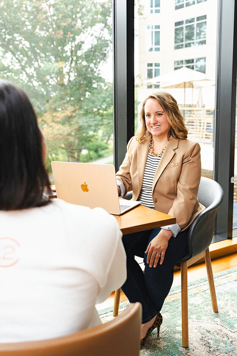 social media manager sitting with a client for a branding photoshoot taken by olya photography