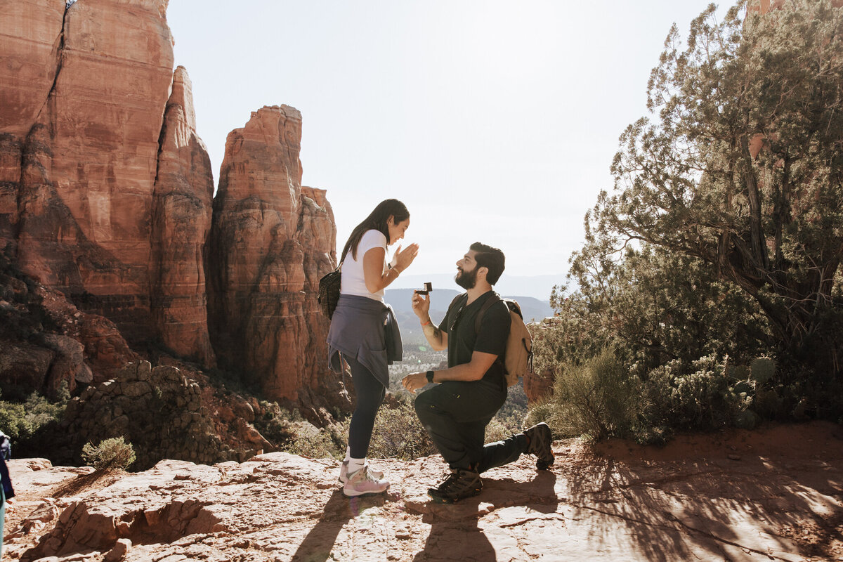 Man proposing at the top of Cathedral Rock during sunset in Sedona, Arizona.