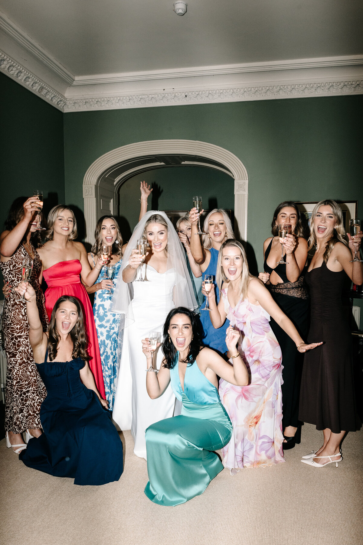 Bride and her bridesmaids holding up their champagne at an Irish wedding