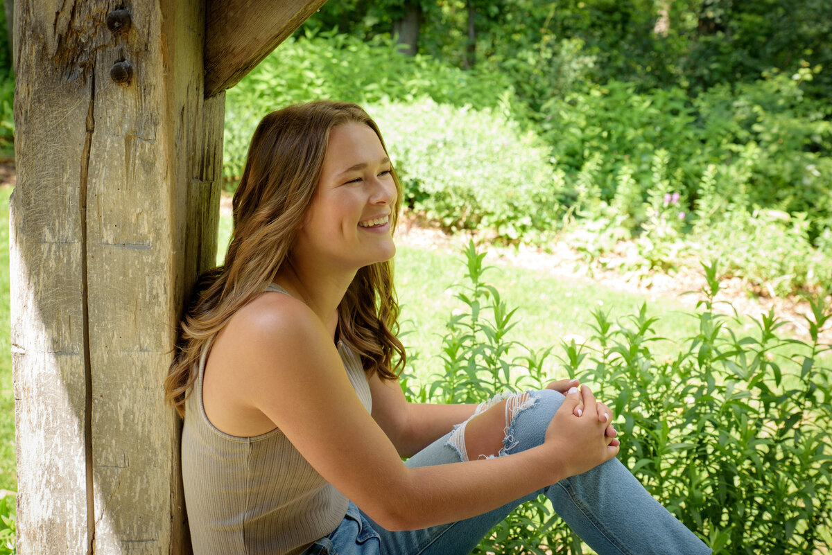 Luxemburg Casco High School senior girl wearing ripped jeans and a tan shirt at the Green Bay Botanical Gardens in Green Bay, Wisconsin