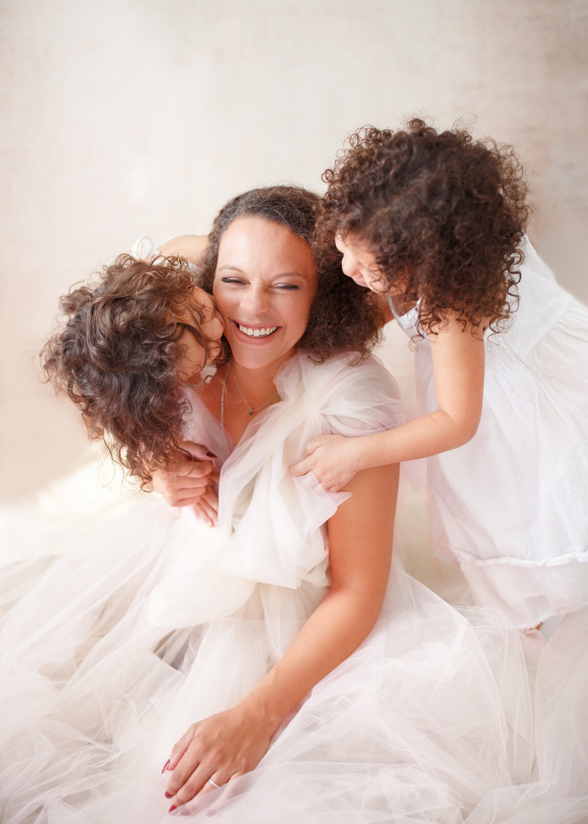 a mom and her two girls in fluffy dresses