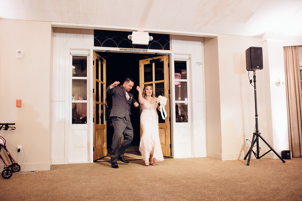 Wedding Photograph Of Groomsman And Bridesmaid Entering The Door Of The Reception Hall Los Angeles