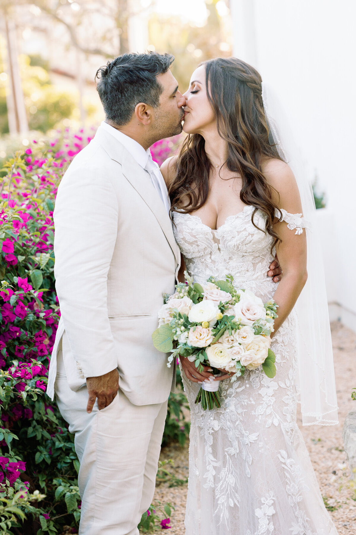 Bride kissing  a groom at the courtyard of Belmond El Encanto