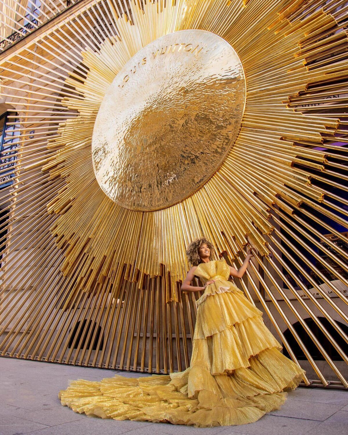 women having a portrait photoshoot in paris wearing a gold princess gown