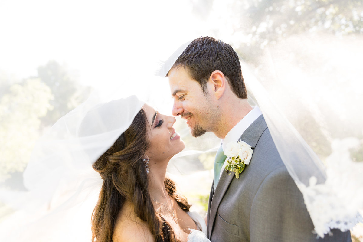 Dallas Wedding couple intimately kissing under veil
