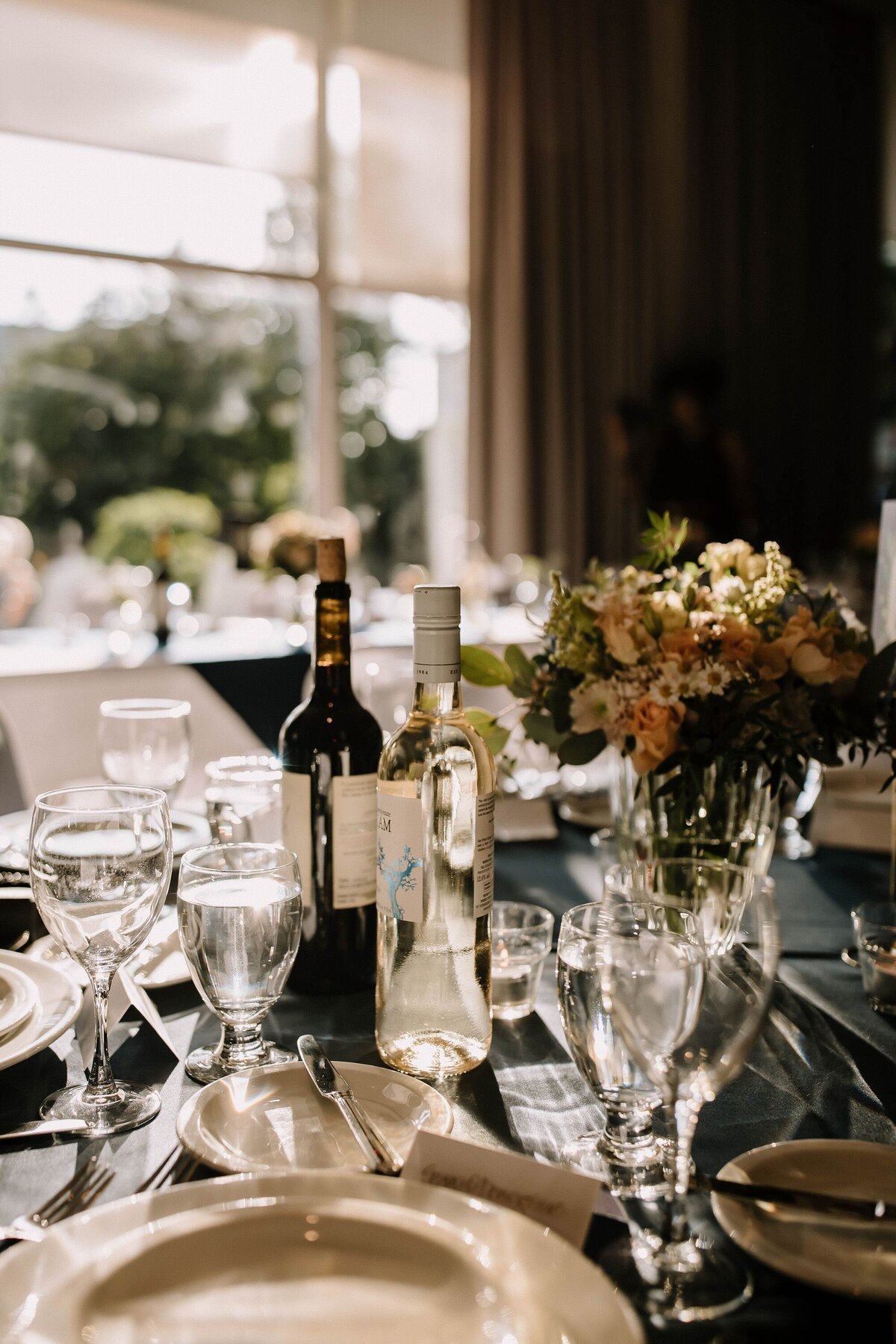 Wedding tablescape with glasses and wine and flowers
