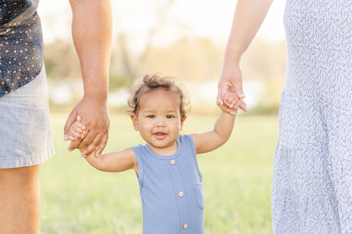 parents holding toddler's hands during Leesburg, Virginia spring mini session