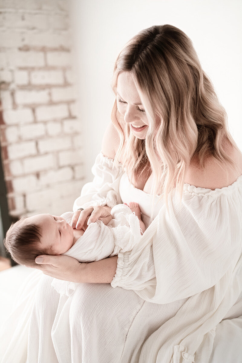 mom holding baby in lap