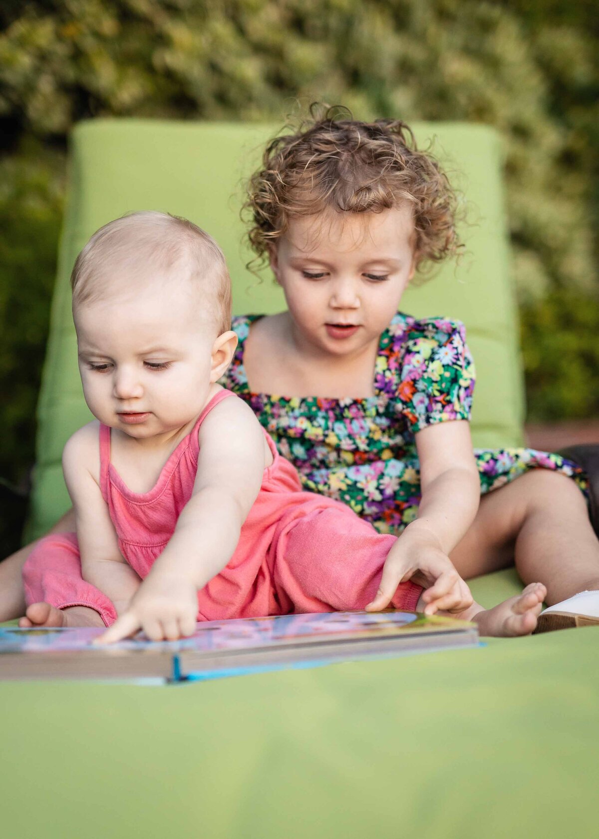 toddlers-reading-on-green-chaise-lounge-