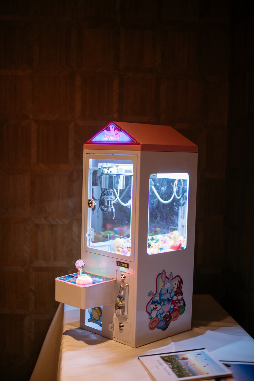 A mini claw machine game at the reception at St. Regis Aspen, adding a fun and playful touch to the celebration.
