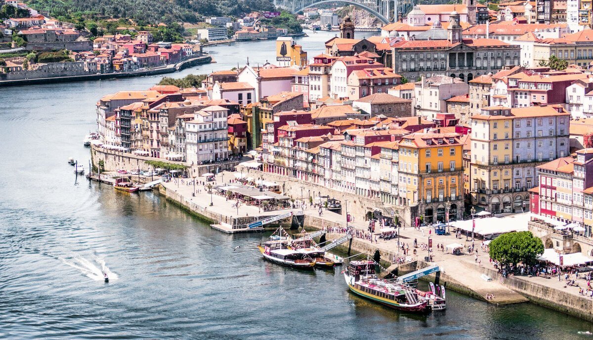 European buildings with boats on a river to show elite personal vacation planner services