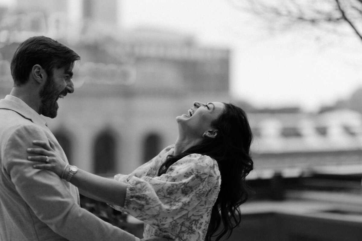 Newly engaged couple celebrates her saying 'YES!' during a downtown Minneapolis rooftop proposal.