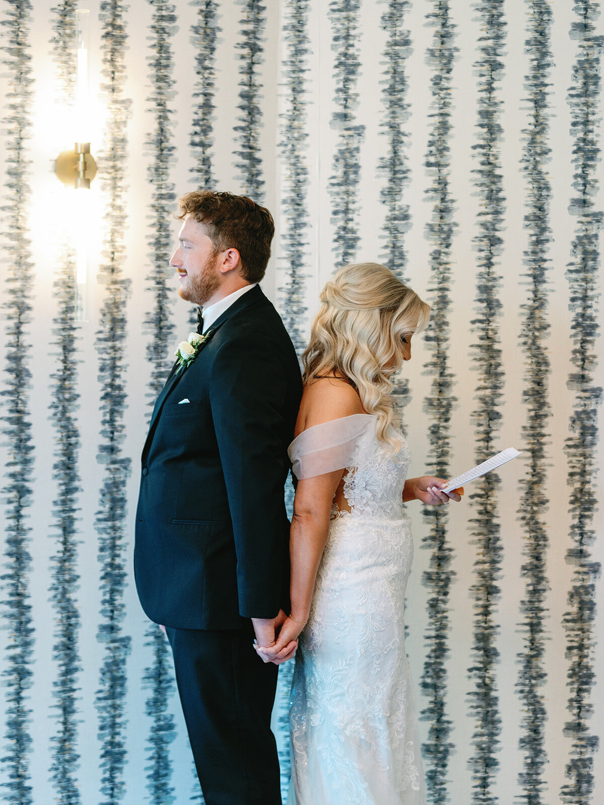 Bride and groom at Memorial Presbyterian Church in St. Louis, holding hands during their first touch