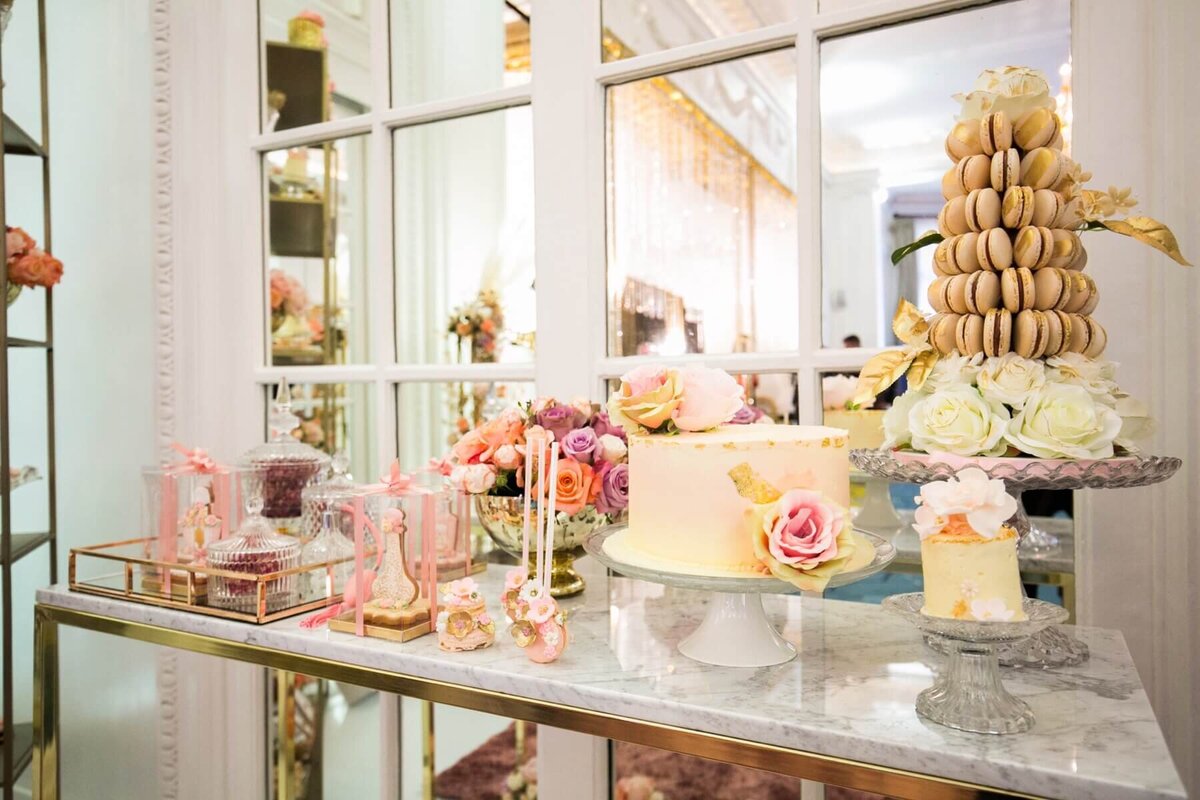 Luxury dessert table with wedding cake, macaroon tower and cake pops decorated with flowers