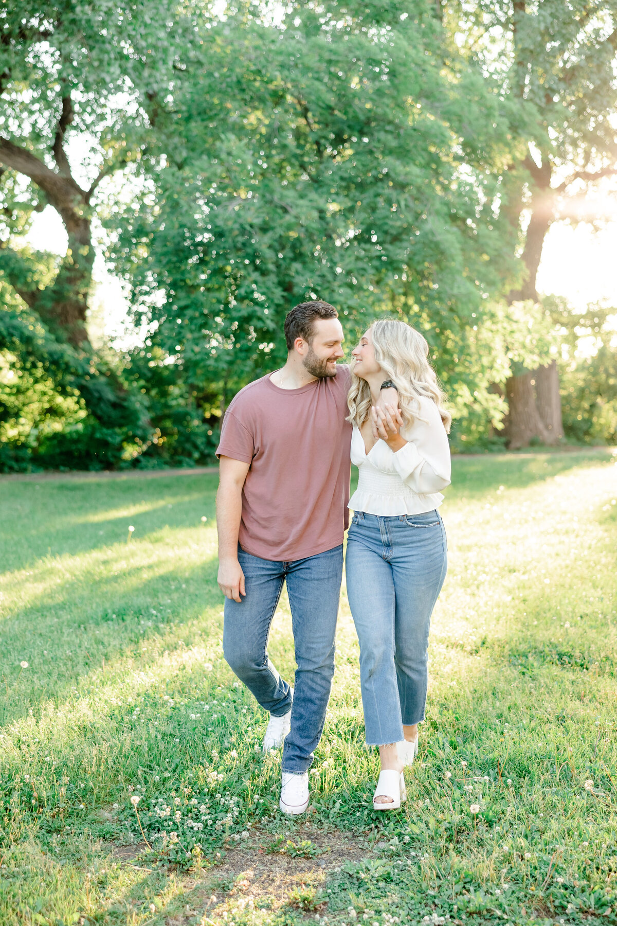 couple walking on grass by wedding photographer in sarasota