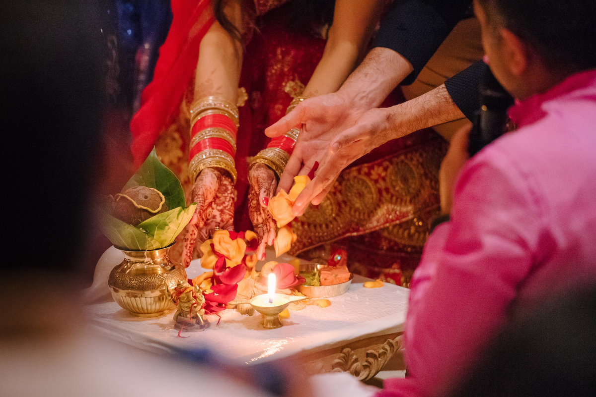 A couple dropping petals as part of a Hindu wedding ceremony