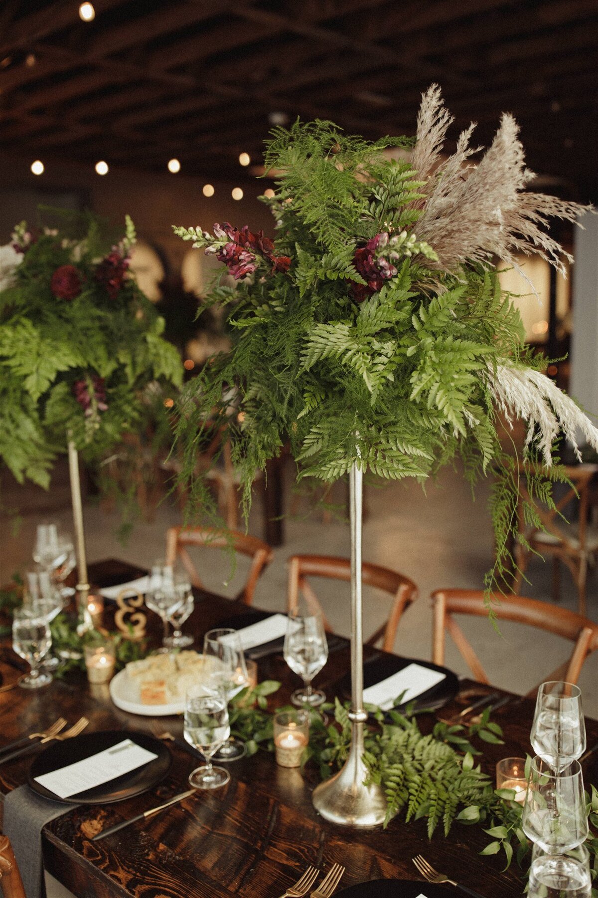 Tall greenry wedding florals for reception tables at the St Vrain, Longmont wedding venue